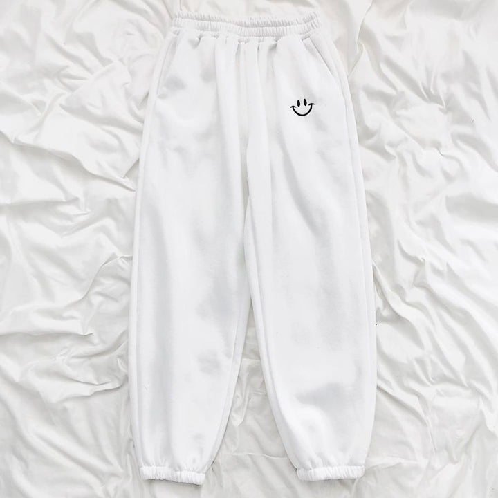 Pantaloni tuta comodi con faccina ricamata